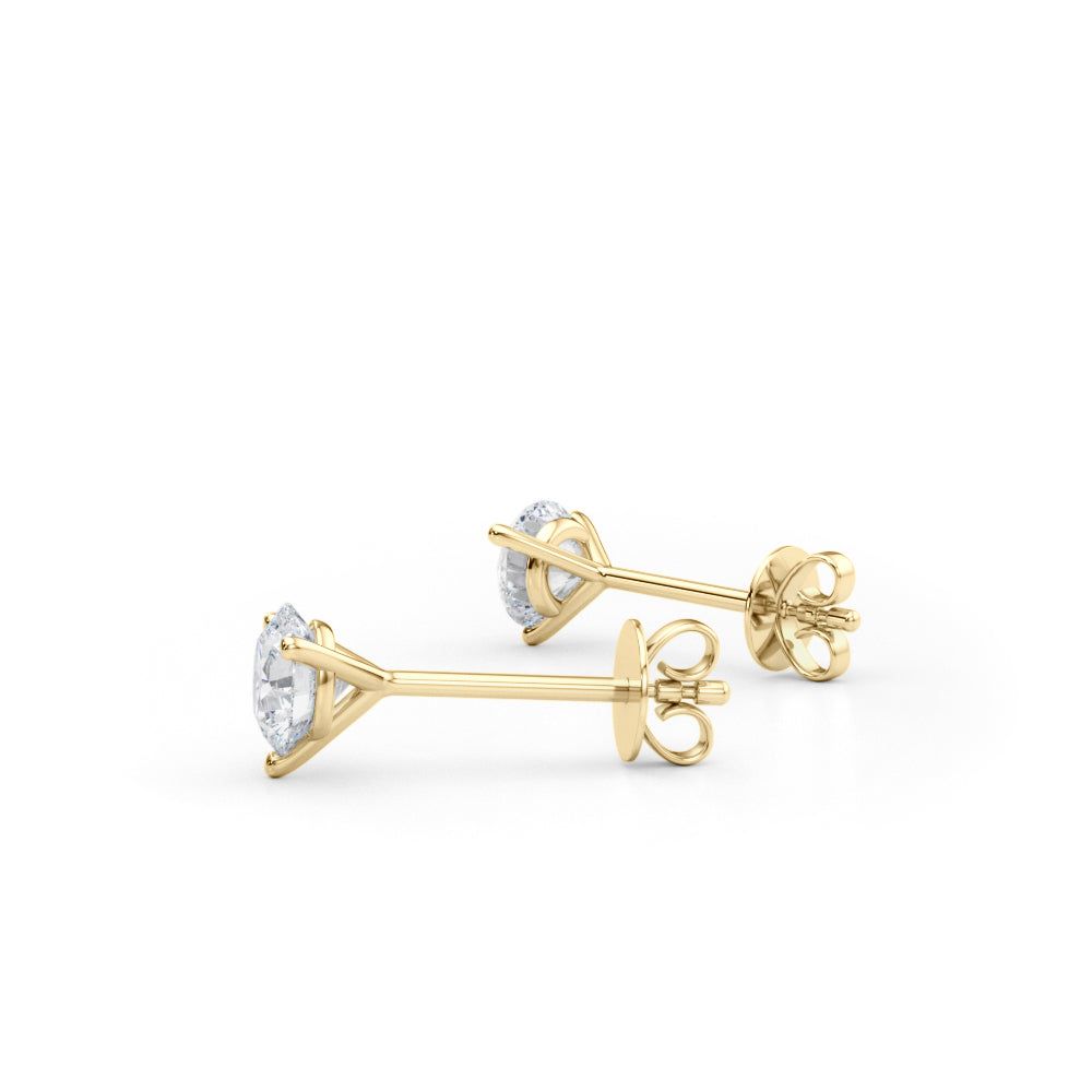 Gold earrings with diamond studs on a white background
